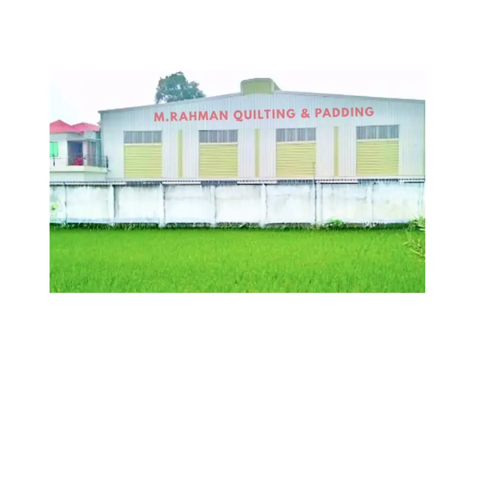 a building structure with green field and white color boudary wall